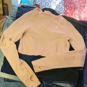 Blush pink gymshark extra small cropped seamless workout top.